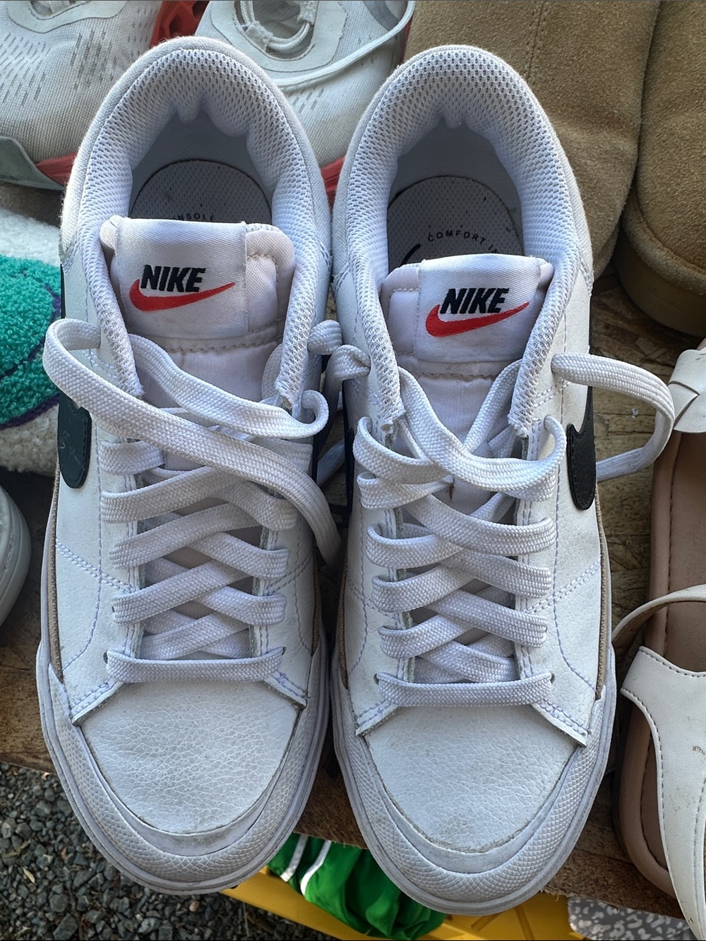 Nike White Low-Top Sneakers with Black Swoosh and Red Logo Patch
